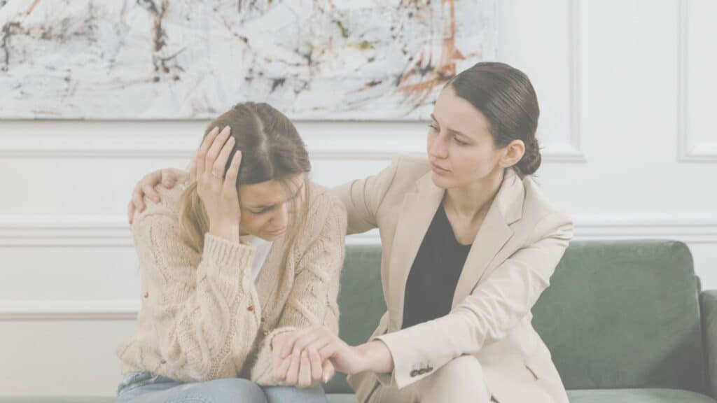 optimistic woman, comforting despairing worman